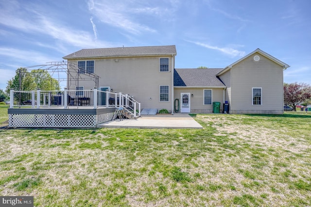 back of house featuring a patio, a lawn, and a deck