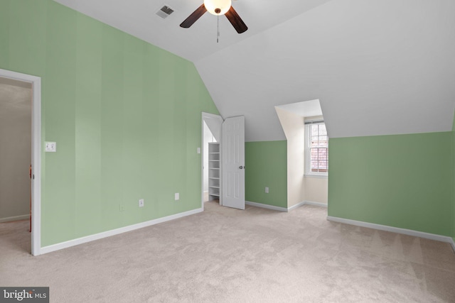 additional living space featuring ceiling fan, visible vents, carpet floors, and vaulted ceiling