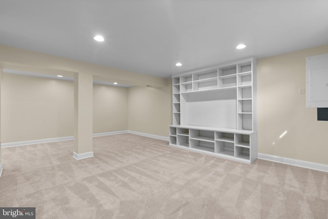 finished below grade area featuring electric panel, carpet floors, baseboards, and recessed lighting
