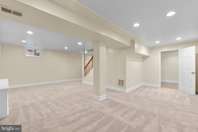 below grade area with baseboards, recessed lighting, light carpet, and visible vents