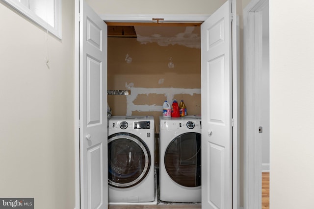 clothes washing area featuring laundry area and washer and dryer