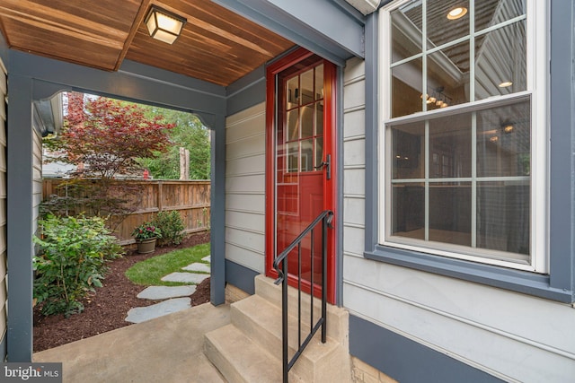 doorway to property featuring fence