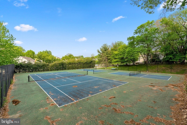 view of tennis court featuring fence