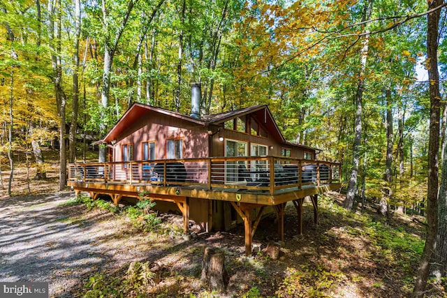 296 Mountainside Rd, Berkeley Springs, WV 25411 - back of property with a wooden deck and a forest view