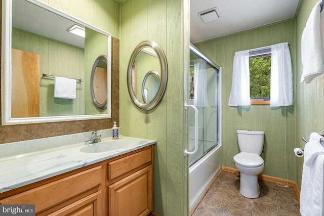 296 Mountainside Rd, Berkeley Springs, WV 25411 - full bathroom with visible vents, vanity, toilet, baseboards, and enclosed tub / shower combo