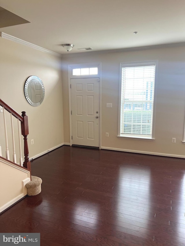 entrance foyer with crown molding, stairs, baseboards, dark wood-type flooring, and visible vents