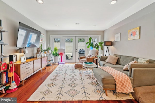 living room featuring recessed lighting, visible vents, french doors, and wood finished floors