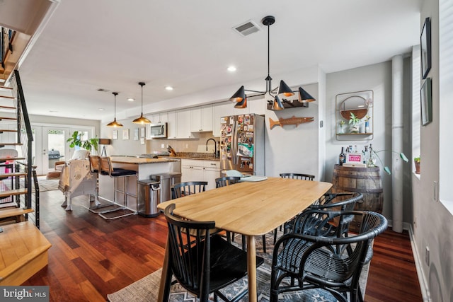 dining room with recessed lighting, visible vents, and dark wood-type flooring