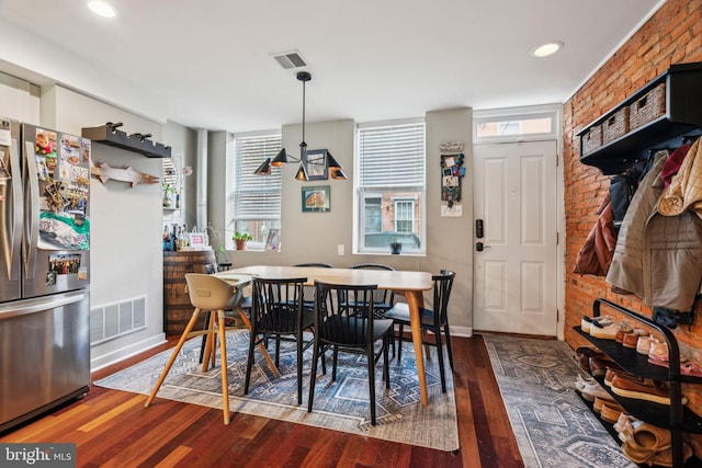 dining room with recessed lighting, baseboards, visible vents, and wood finished floors