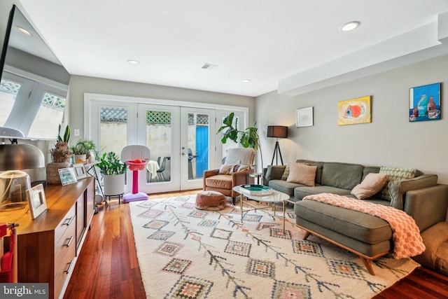 living area with french doors, recessed lighting, wood finished floors, and visible vents