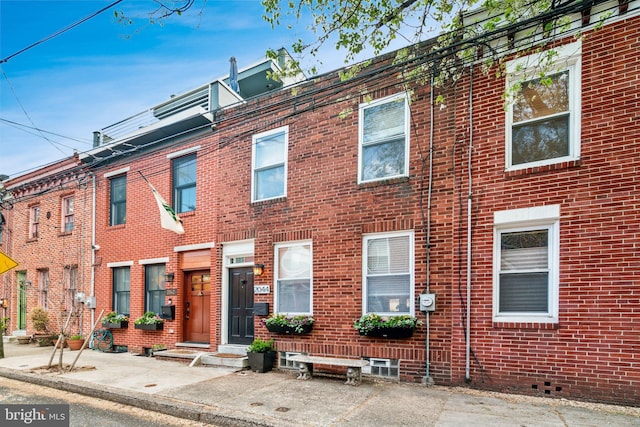 view of property featuring brick siding