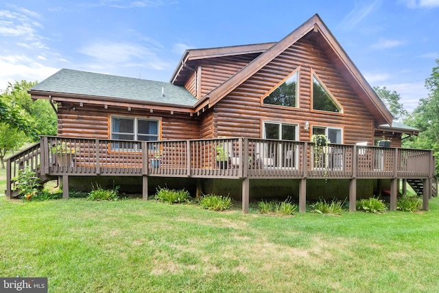 back of property with a yard, a deck, log exterior, and roof with shingles