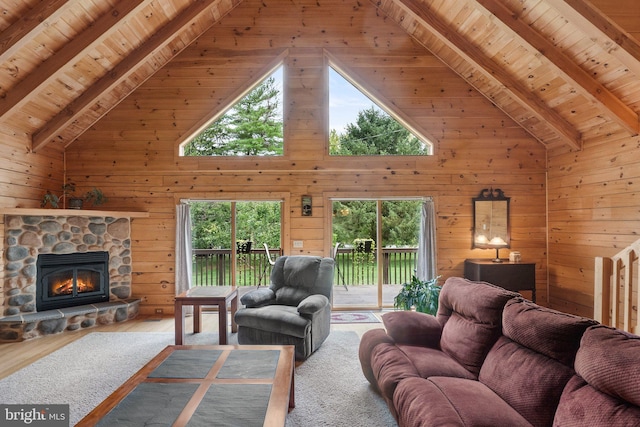 living area featuring beamed ceiling, high vaulted ceiling, and wooden ceiling