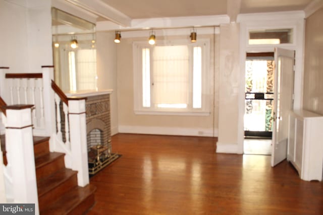entrance foyer with baseboards, a healthy amount of sunlight, wood finished floors, and stairway