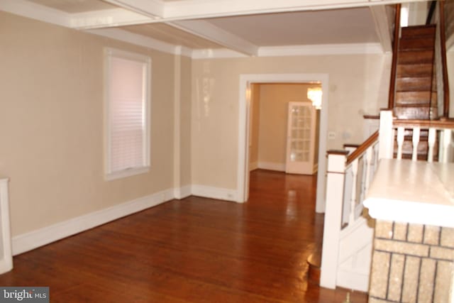 interior space featuring baseboards, wood finished floors, and beam ceiling
