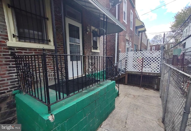 exterior space featuring fence and covered porch