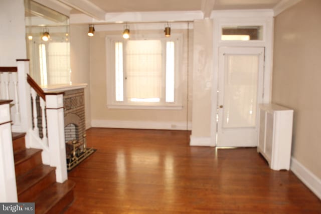 entryway with stairs, baseboards, and wood finished floors