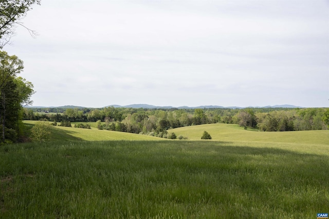 view of home's community featuring a mountain view and a yard