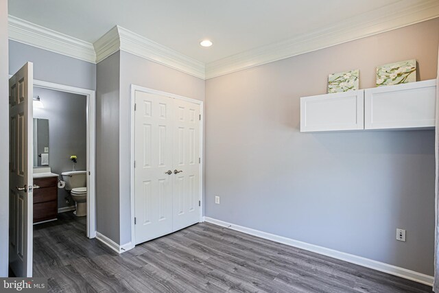 8004 Ink Berry Ct Unit D-3, Pasadena, MD 21122 - unfurnished bedroom featuring dark wood-style flooring, crown molding, baseboards, a closet, and recessed lighting