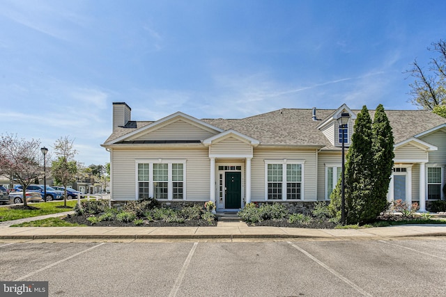 8004 Ink Berry Ct Unit D-3, Pasadena, MD 21122 - view of front facade with a shingled roof, a chimney, uncovered parking, and stone siding