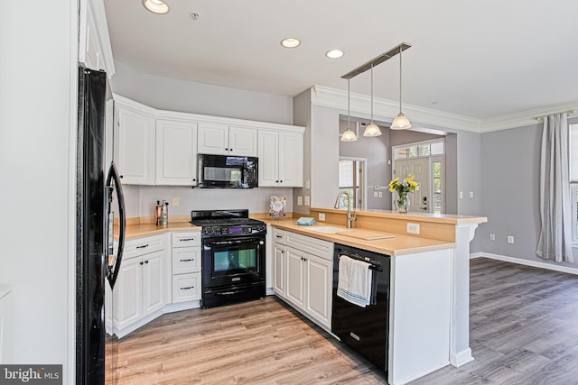 8004 Ink Berry Ct Unit D-3, Pasadena, MD 21122 - kitchen featuring a sink, light wood finished floors, a peninsula, recessed lighting, and black appliances