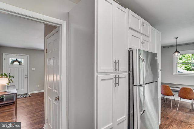 4001 Patricia St, Annandale, VA 22003 - kitchen featuring freestanding refrigerator, dark wood-style flooring, baseboards, white cabinetry, and decorative light fixtures