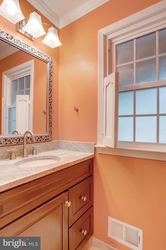 bathroom with visible vents, crown molding, and vanity
