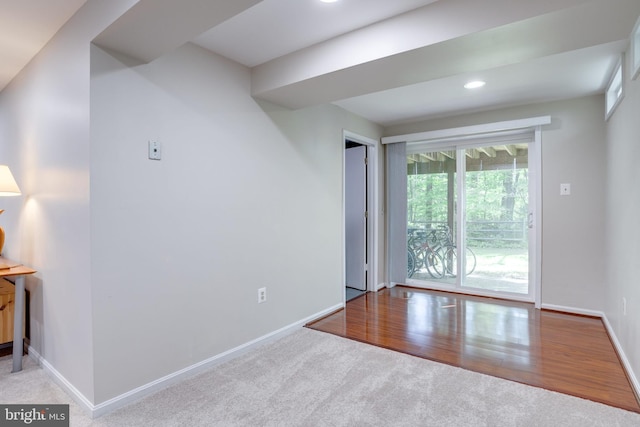 unfurnished room featuring baseboards, carpet flooring, recessed lighting, and wood finished floors