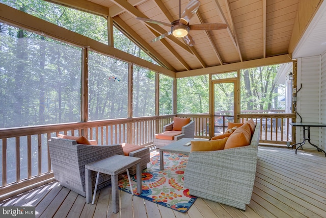 sunroom with ceiling fan, outdoor lounge area, and beamed ceiling