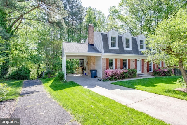 cape cod-style house with a chimney, a front yard, roof with shingles, brick siding, and concrete driveway