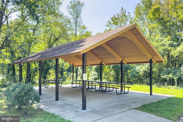 view of community featuring a gazebo, a detached carport, and a lawn
