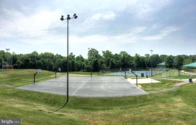 view of basketball court featuring community basketball court and fence