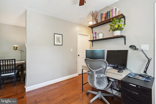 office area featuring baseboards, a ceiling fan, and wood finished floors