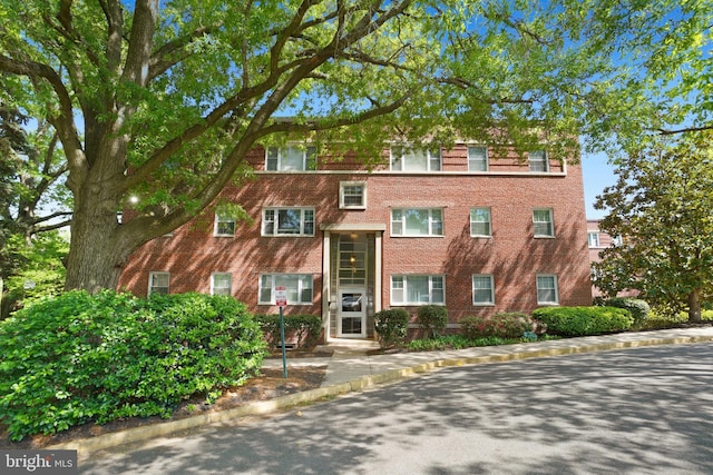 view of property featuring brick siding
