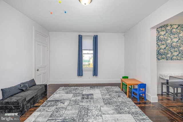 playroom featuring baseboards and wood finished floors