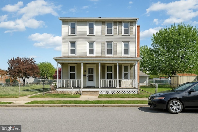 view of front of property featuring fence, a porch, and a front yard