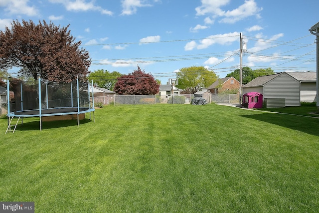 view of yard featuring a fenced backyard and a trampoline