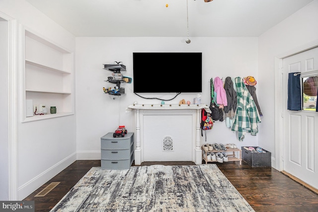 bedroom featuring baseboards and wood finished floors