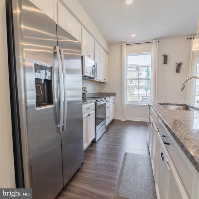 kitchen featuring a sink, dark wood-style flooring, white cabinetry, and stainless steel appliances