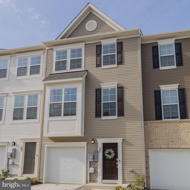 townhome / multi-family property with a garage and driveway