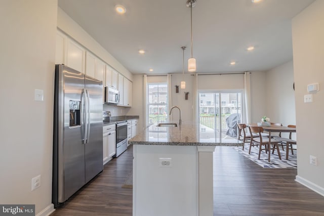 kitchen featuring white cabinets, stainless steel appliances, dark wood finished floors, and a sink