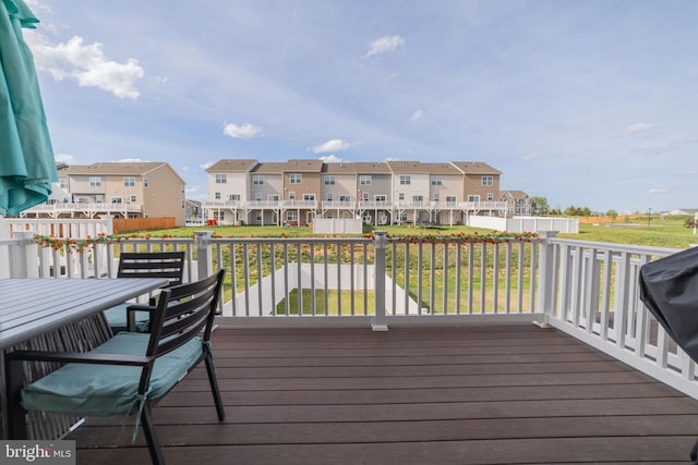 wooden terrace with a yard and a residential view