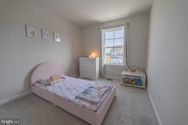 bedroom featuring baseboards, carpet flooring, and visible vents