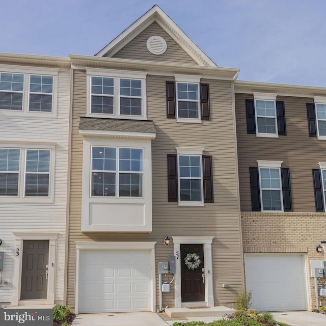 townhome / multi-family property with a garage and driveway
