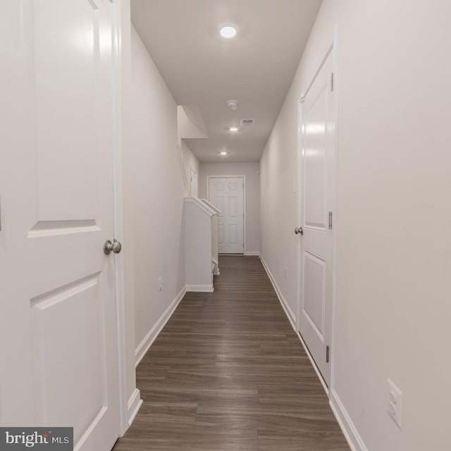 hall with baseboards, recessed lighting, dark wood-style floors, and visible vents