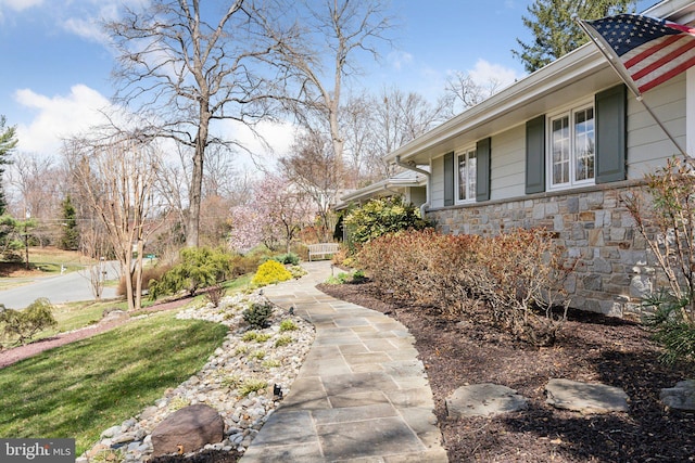 view of side of home featuring stone siding