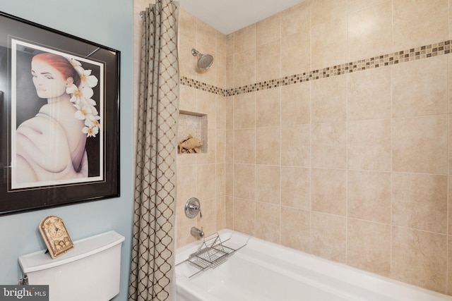 bathroom featuring shower / bath combo with shower curtain and toilet