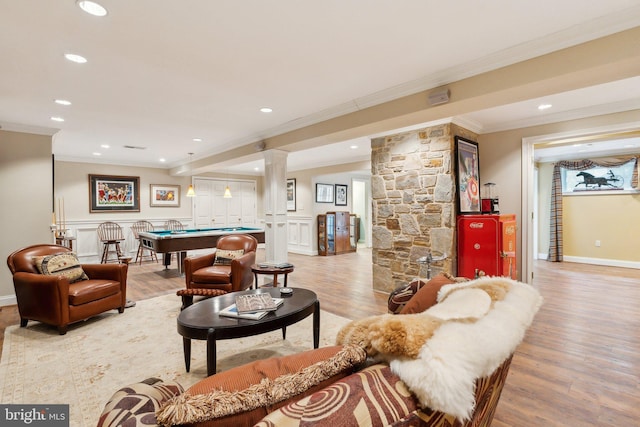living room featuring light wood-style floors, pool table, ornamental molding, and decorative columns