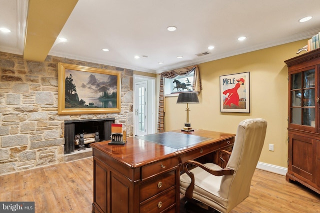 office space with crown molding, visible vents, a fireplace, recessed lighting, and light wood-style flooring