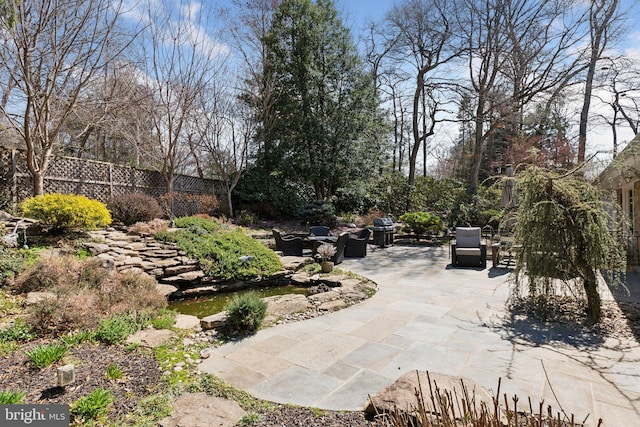 view of patio featuring fence and area for grilling